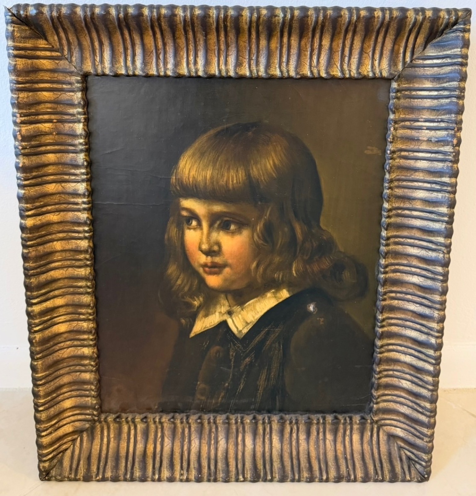 Oil portrait of a young child in a ruffled white collar, in a gilt reeded frame